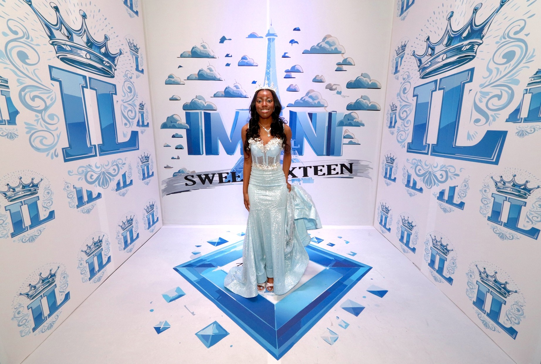 Woman smiling in a blue dress with a tiara